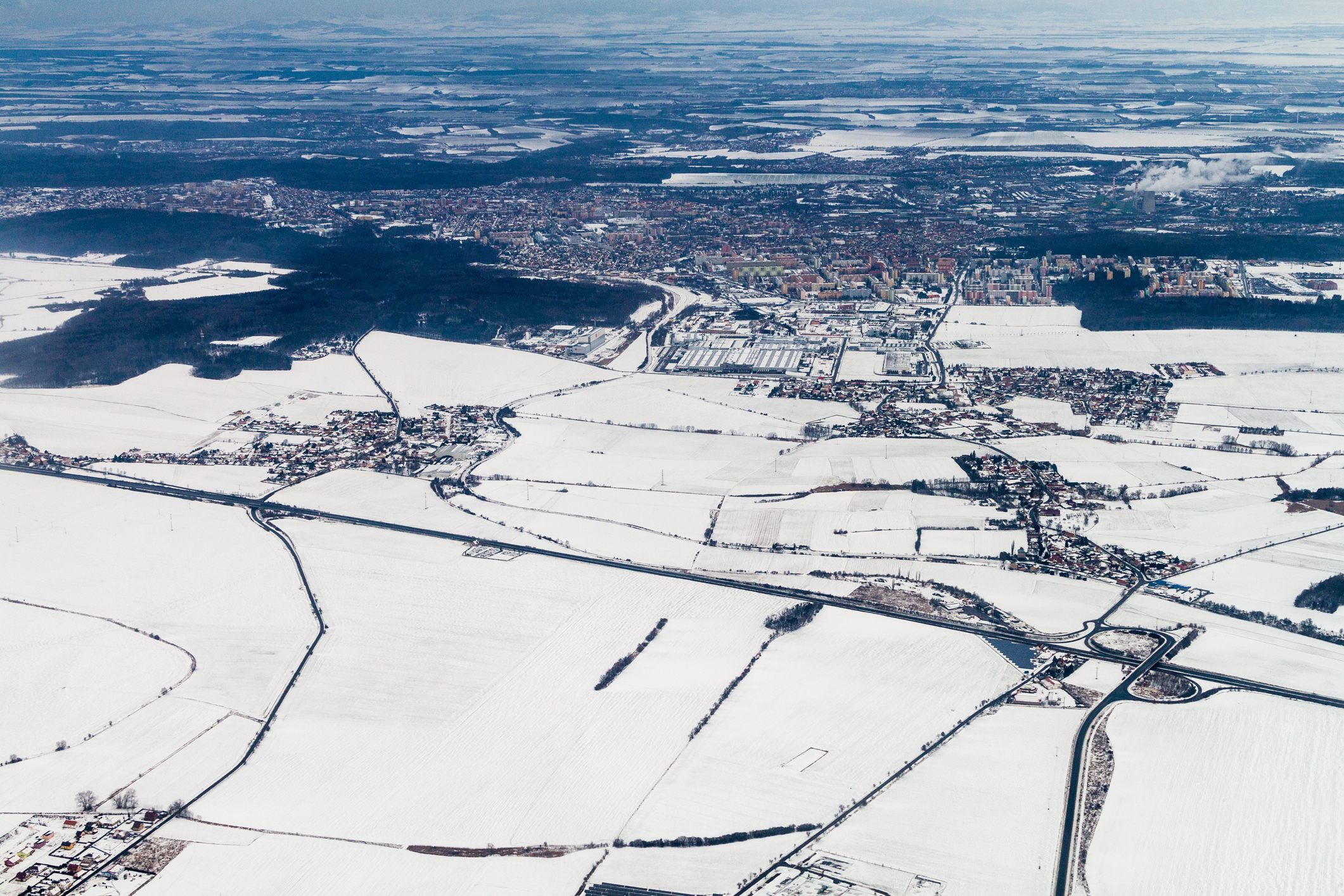 Winter aerial view of the landscape of the Czech Republic. D6 freeway and Kladno city.
